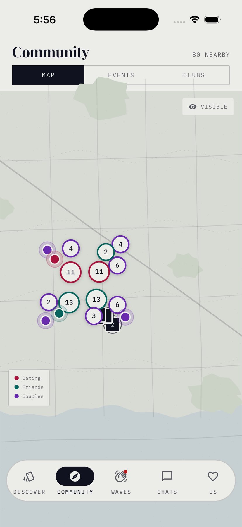 The Kindred map: a real street map of the city with coloured dots for people, numbered bubbles where several are close together, and circular icons marking cafes and restaurants